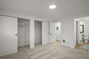 a bedroom with a carpeted floor and white walls at Chalet, Springfield